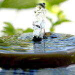 Water flowing gently over a ceramic garden fountain, an image of quiet receptivity from Kyle Strobel's When God Seems Distant — spiritual formation isn't about filling yourself up.
