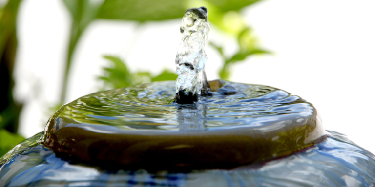 Water flowing gently over a ceramic garden fountain, an image of quiet receptivity from Kyle Strobel's When God Seems Distant — spiritual formation isn't about filling yourself up.