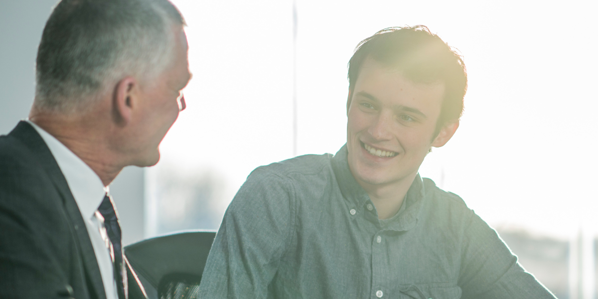 An older pastor mentoring a younger man, reflecting the call to identify and develop spiritually mature future ministers